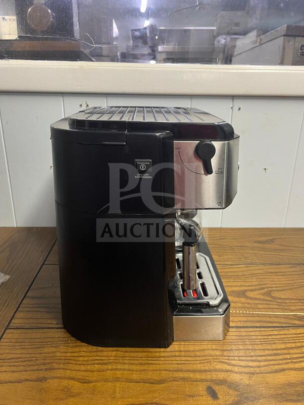DELONGHI BCO430 coffee machine, black and silver, side view. Features espresso, drip coffee, frothing wand.