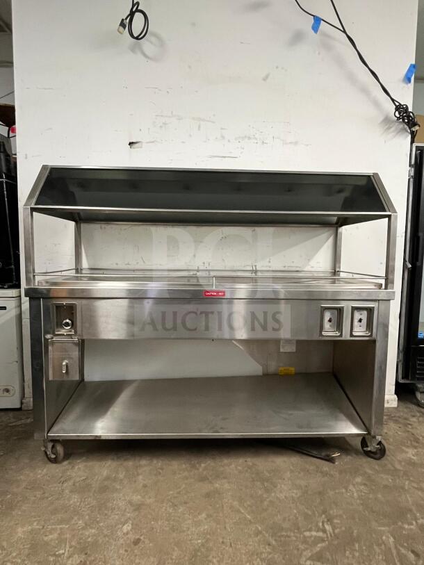 Stainless steel Gaylord hot food steam buffet table in excellent condition, model buffet table, features shelving and heating controls.