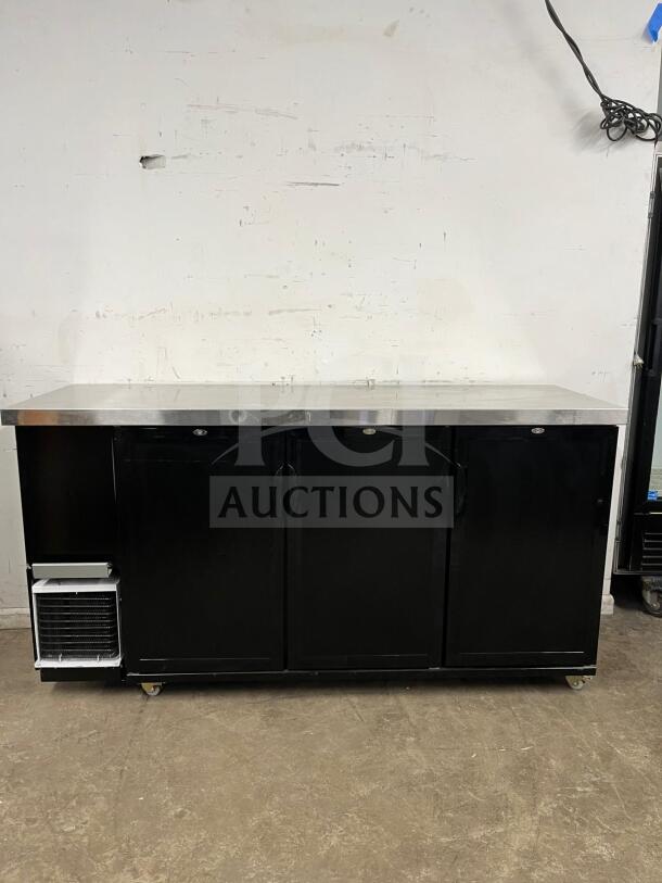Dukers DBB72 back bar beverage cooler with stainless steel top, black exterior, three doors, and visible cooling unit.