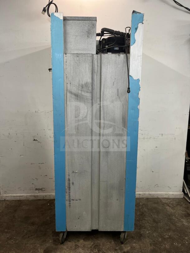 TRAULSEN G10010 reach-in refrigerator, 30", solid door, right hinged, industrial model with visible wear, on wheels.