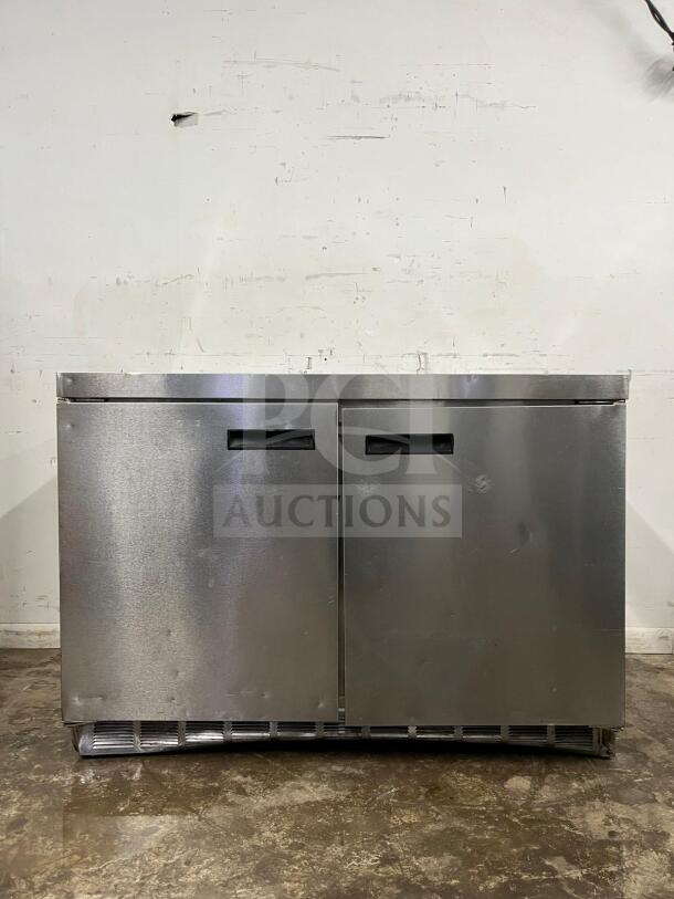 Delfield 4448NP-18M 48" refrigerated salad prep table, stainless steel, two doors, holds 18 pans, good condition.