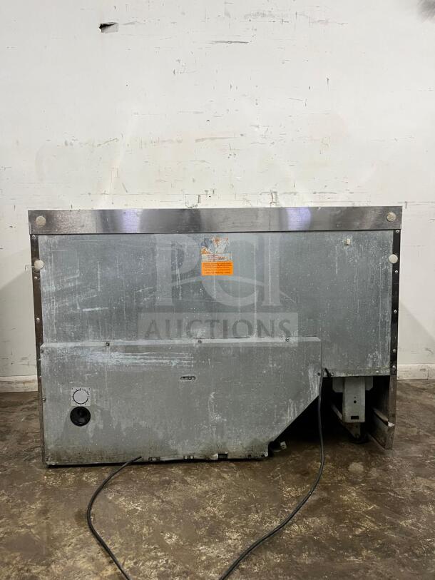 Delfield 4448NP-18M refrigerated salad prep table cooler, 48", visible wear, metal surface, electric cord attached.