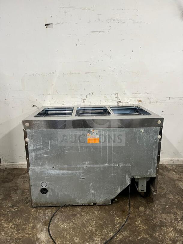 Delfield 4448NP-18M refrigerated mega top salad prep table, 48 inches, holds 18 pans, visible wear on exterior, orange label.