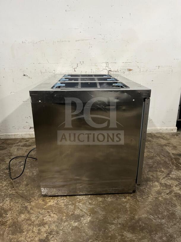 Delfield 4448NP-18M salad prep table with 18 pans. Stainless steel, used condition, shows side view and power cord.