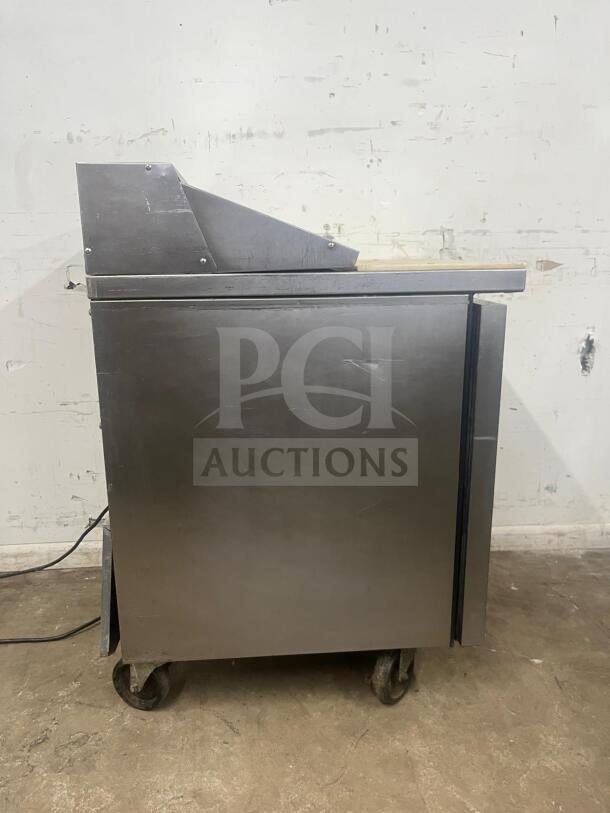 True TSSU-27-08-HC refrigerated sandwich prep table, stainless steel, right-hinged door, on wheels, in used condition.