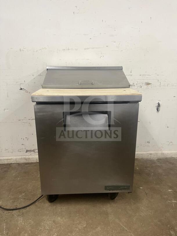 True TSSU-27-08-HC refrigerated prep table, stainless steel, 27 7/8", right-hinged door, used condition, on casters.