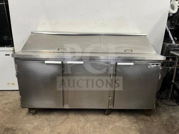 LEADER NSFM72 72" three-door refrigerated prep table for sandwiches and salads. Stainless steel, mega top design, good condition.