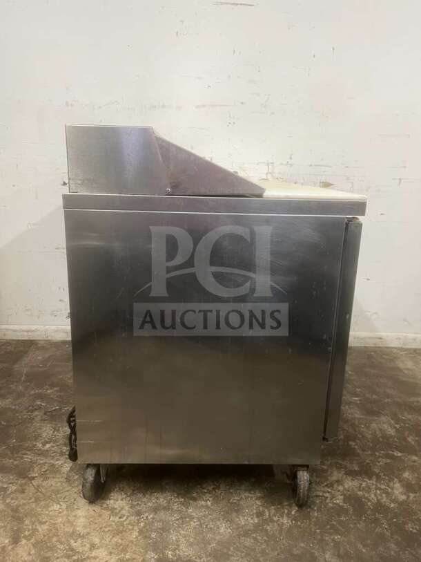 Beverage-Air 48" 2-door sandwich prep table, stainless steel, on wheels, minor wear, ideal for commercial kitchen use.