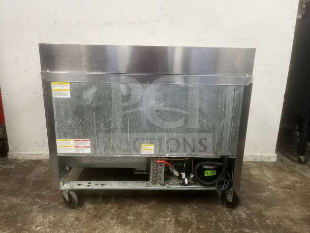 Beverage-Air 48" 2 Door Sandwich Prep Table, stainless steel, model unknown, visible wear, on casters, rear view with label R290.