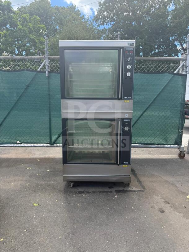 HOBART electric rotisserie oven and warmer HRW 303, dual-unit, stainless steel, wheels for mobility, visible control knobs.