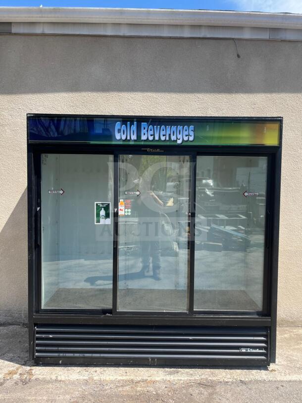 TRUE GDM-69 three-section glass door merchandiser with sliding doors, black, "Cold Beverages" sign, excellent condition.