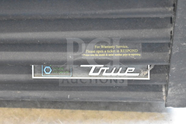 2017 True GDM-72F-HC Commercial 3 Door Freezer, black exterior, warranty service and natural refrigerant labels visible.