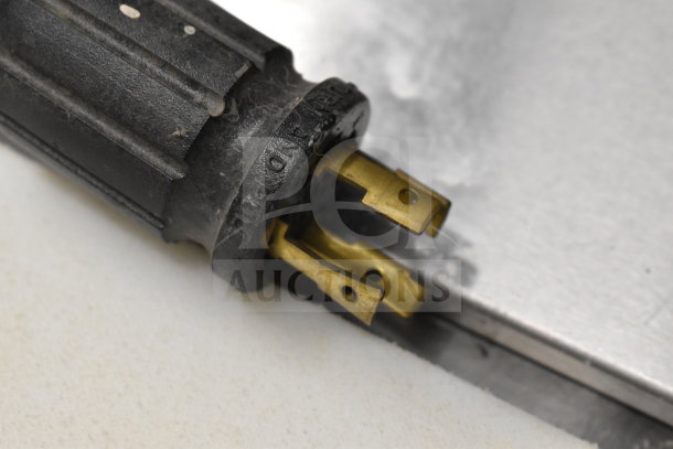 A power plug with three prongs designed for the 2017 True GDM-72F-HC freezer, showing wear but intact condition.