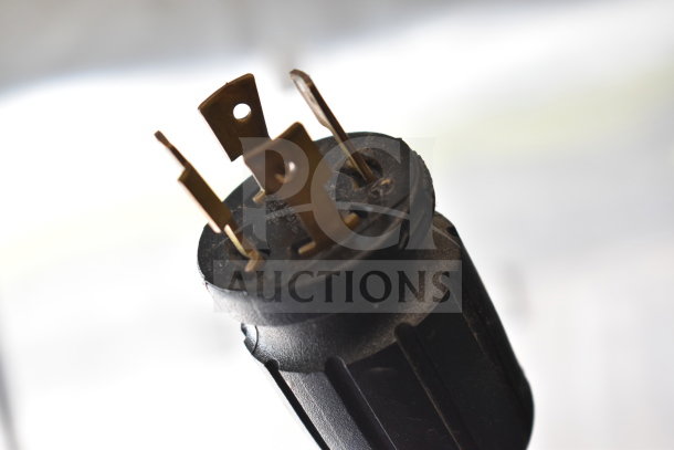 Close-up of power plug for True GDM-72F-HC freezer merchandiser, showing prongs and connector details.