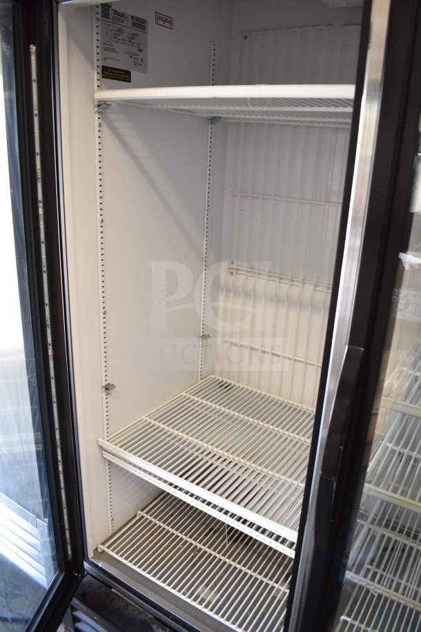 2017 True GDM-72F-HC 3-door commercial freezer, shelves visible, label shows voltage specs; tested and working.