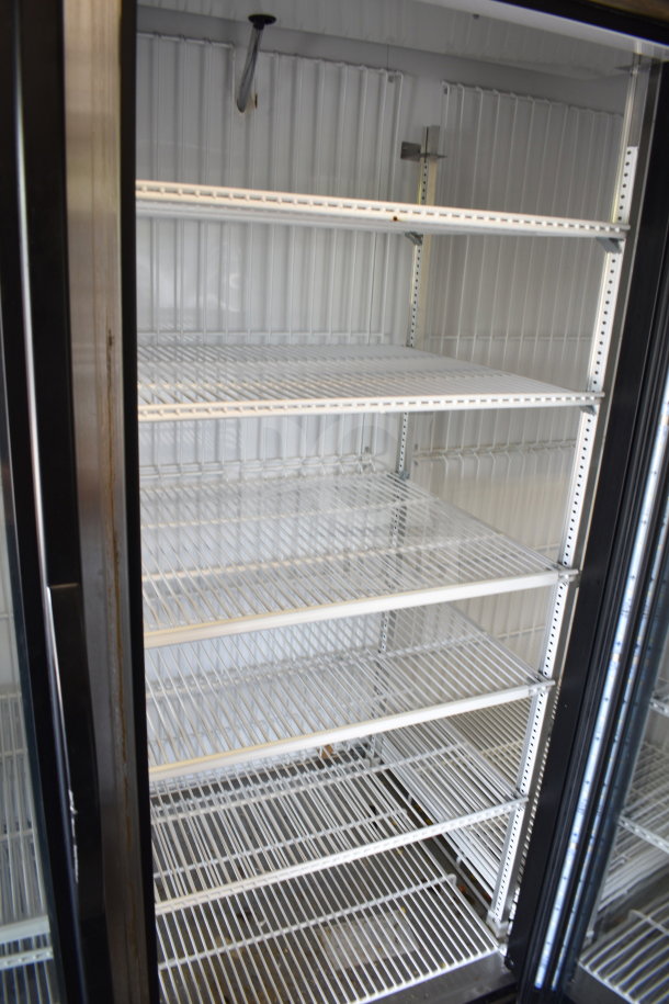 2017 True GDM-72F-HC 3-door reach-in freezer, tested working, with white wire shelving, black trim, and glass doors.