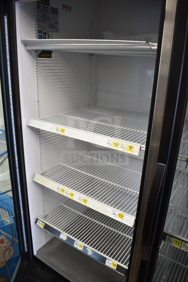 2019 True GDM-49-HC commercial 2-door reach-in cooler, tested and working, with adjustable shelves and visible pricing tags.