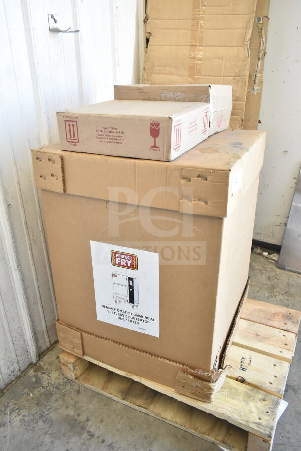 Brand new 2024 Perfect Fry PFC730 semi-automatic ventless countertop deep fryer in original packaging on a pallet.