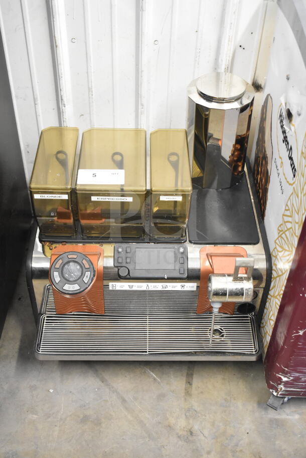 Thermoplan Mastrena stainless steel espresso machine with LCD display, hoppers labeled "Blonde," "Espresso," "Decaf," and steam wand.