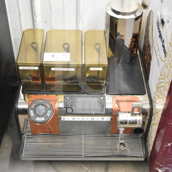 Thermoplan Mastrena stainless steel espresso machine with LCD display, hoppers labeled "Blonde," "Espresso," "Decaf," and steam wand.