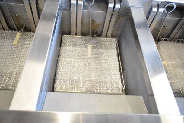 2021 Frymaster 3FQE30U0ZQ3ZZ14 electric 3-bay fryer, stainless steel, 208V, 3-phase, with protective bubble wrap.