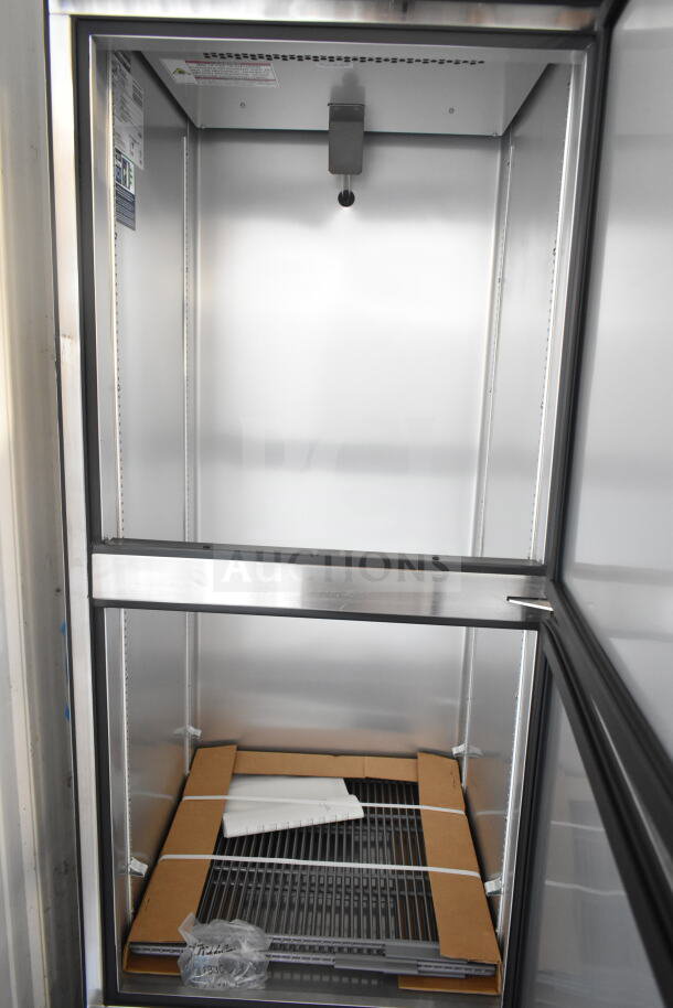 Brand new 2021 True T-23-2-HC commercial cooler, 2 half-size doors, on casters, 115V, 1 phase, minor scratches, interior view.