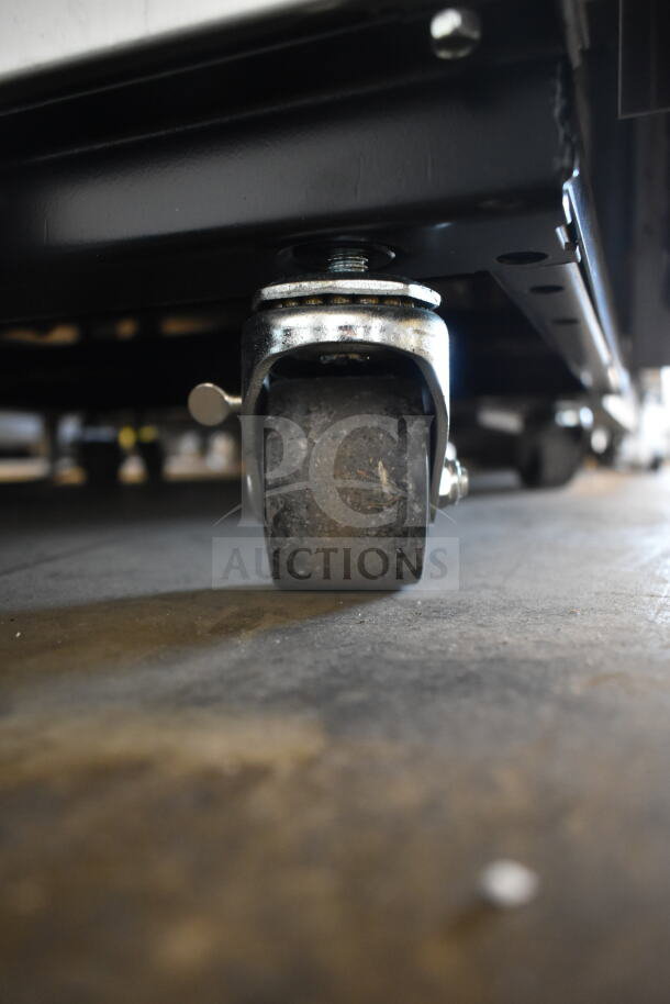 Close-up of caster wheel on a 2021 True T-23F-2-HC-MC commercial freezer. Brand new, scratch and dent condition.