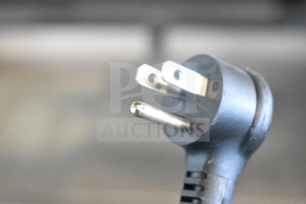 Close-up of a power plug for the 2021 True T-23F-2-HC-MC commercial freezer, 115 volts, 1 phase.