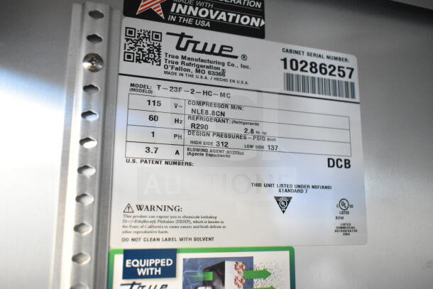 Label for True T-23F-2-HC-MC commercial freezer showing voltage, refrigerant, and design pressures.