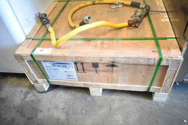 Crated Spectrum NGHP-6 Gas 6 Burner Range, brand new with scratches and dents. Shipping labels and yellow hose visible.