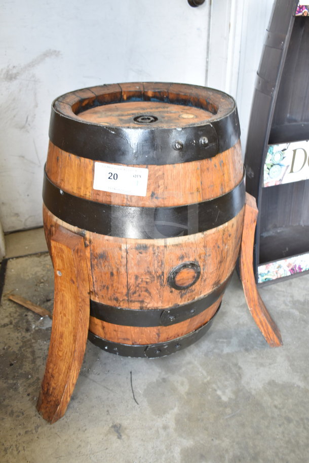 Wooden barrel with metal bands and two detached wooden supports. Auction tag marked "20" indicates item number.