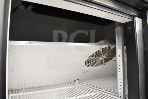 True T-35 commercial 2-door reach-in cooler interior, showing shelving and fan. 115 volts, 1 phase, durable construction.