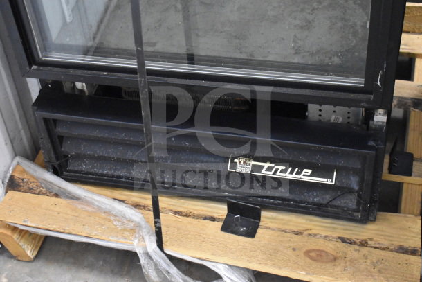 True GDM-12 Commercial Cooler Merchandiser, single door, 115 volts, 1 phase, visible wear, True logo on bottom panel.