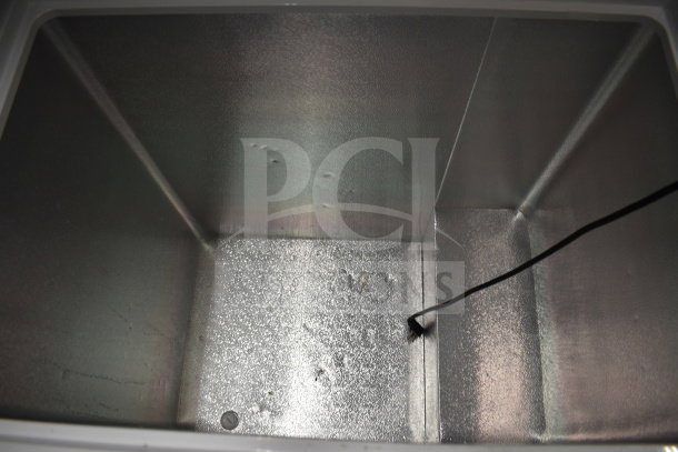 Hisense WFC070M6RWD chest freezer interior, metallic finish. 115 volts, 1 phase. Appears clean and in good condition.