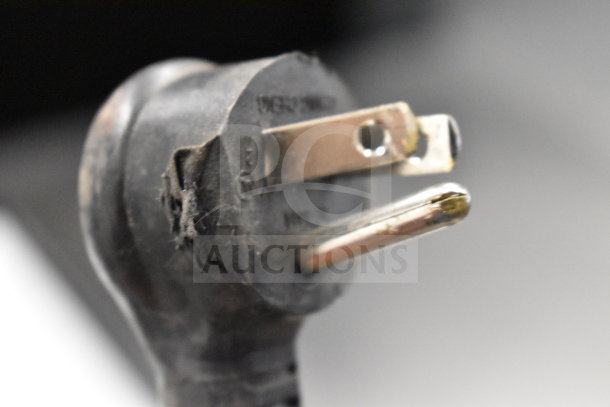 Close-up of a power plug for a 2018 True GDM-06-34-HC Single Door Mini Cooler. Plug shows wear, suitable for 115 volts, 1 phase.