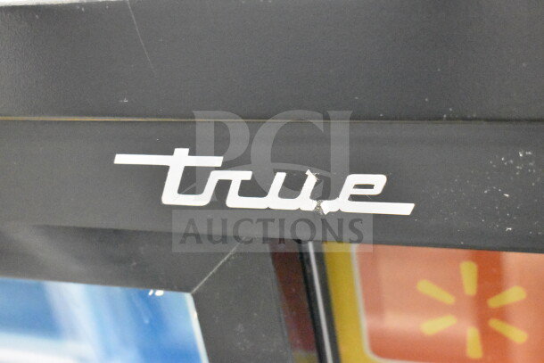 2018 True GDM-41SL-48-HC-LD cooler, logo detail, black frame, commercial use, visible wear on logo area.