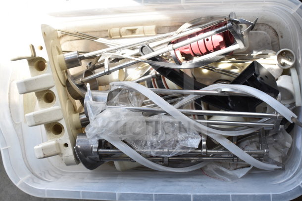 Lot of ice cream machine parts, including augers and various components in two bins, mixed condition.