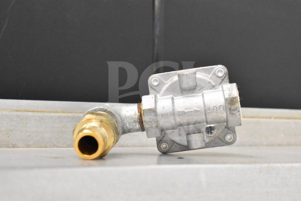 Commercial natural gas valve, metal and brass, engraved with "IN" and "OUT." Clean condition, part of Mainstreet 541E60N range.