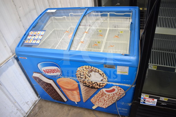 AHT RIO S 100 commercial chest freezer, blue exterior with ice cream graphics, glass sliding doors; 115V, 1 phase.