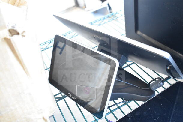 Two Toast POS monitors on a metal shelf, sleek design. Great condition, includes stands and visible branding.