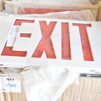 Box containing nine items, featuring a red and white "EXIT" sign. Auction label with "55" and "9X9" visible.