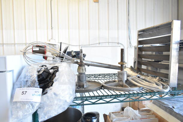 Lot includes whisk, two Pelican head blades, and flat beater mixer attachment on metal shelf, good condition.