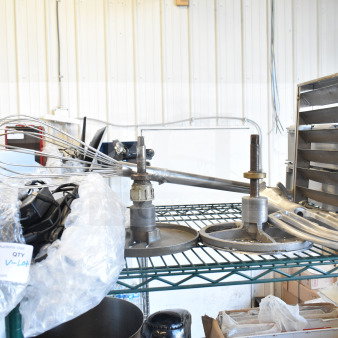 Lot includes whisk, two Pelican head blades, and flat beater mixer attachment on metal shelf, good condition.