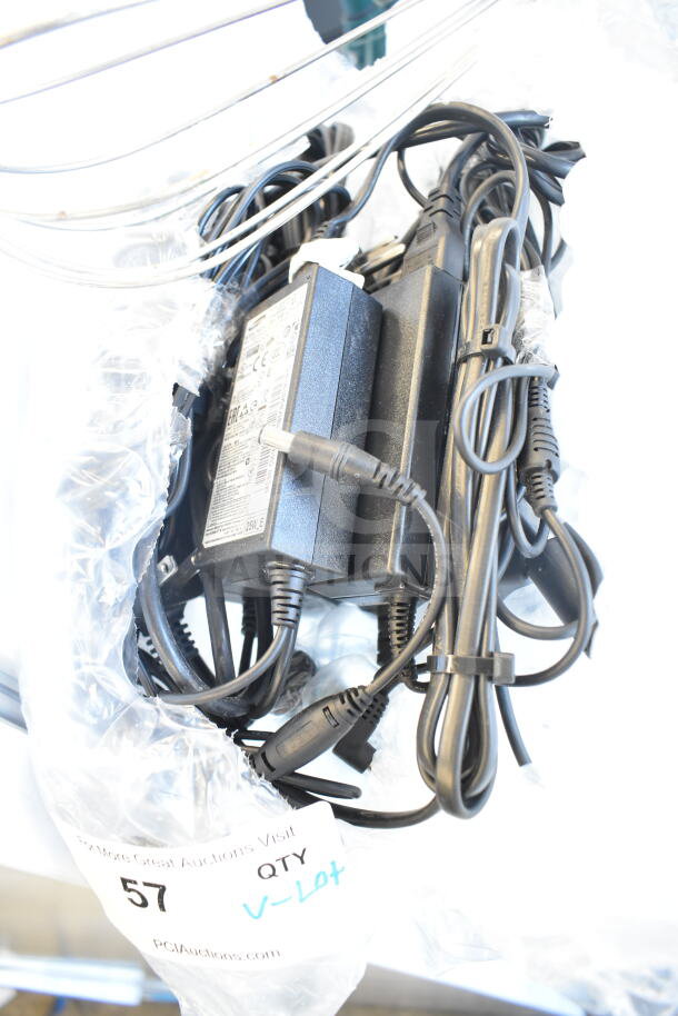 Bundle of assorted items, including a whisk, 2 Pelican head blades, and a flat beater mixer attachment, in a clear bag.
