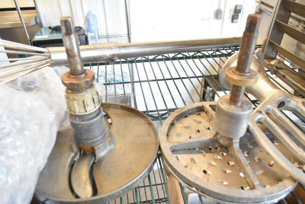 Lot includes a whisk, 2 Pelican head blades, and flat beater mixer attachment on metal rack. Used condition.