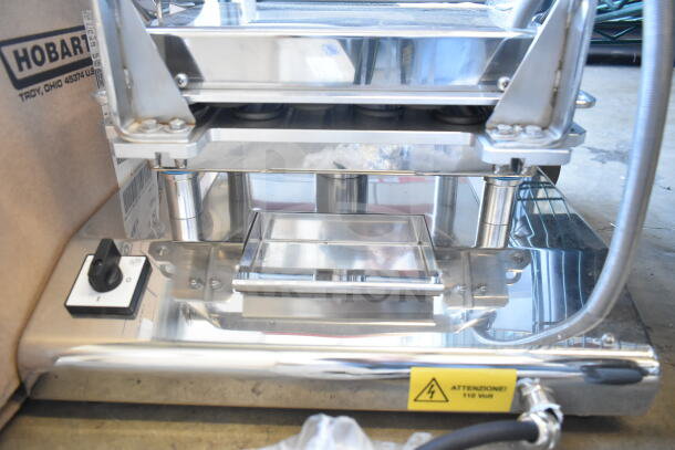 Pavoni Newcookmatic V1 pastry press, stainless steel, 110V, single phase, excellent condition, safety voltage label visible.