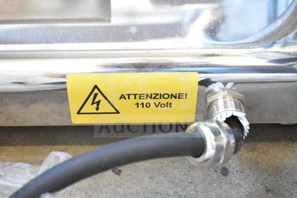 Pavoni Newcookmatic V1 commercial pastry press, 110V, features yellow voltage warning label, robust chrome exterior.