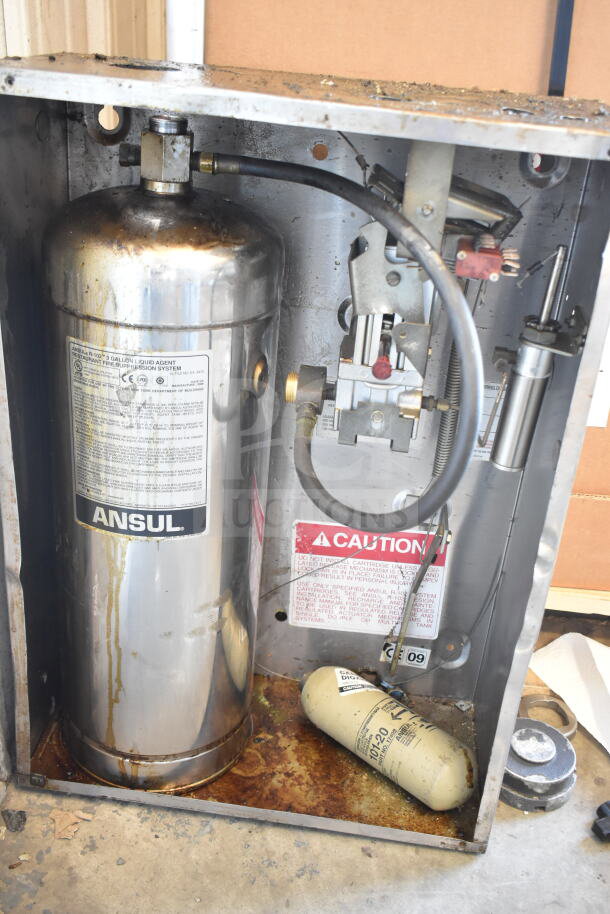 Ansul Fire Suppression System Box with Tank, visible labels, signs of wear, steel construction, caution label included.