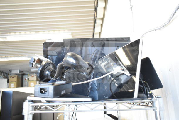 Four POS monitors with stands and cords, mixed condition, on a metal shelf. Includes power adapters and visible Coast logo.