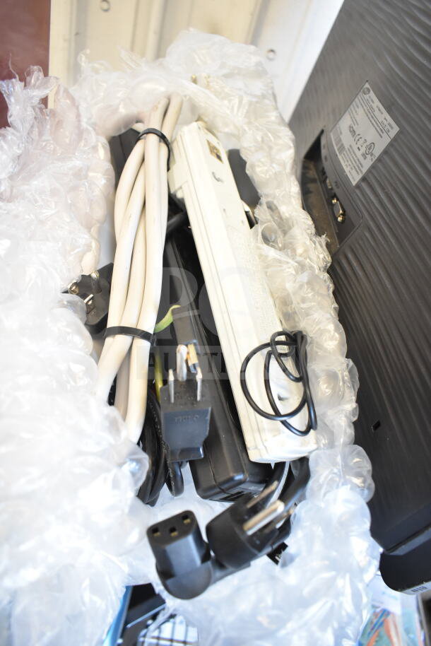 4 various items including a POS monitor, cables, and power strips. Items are wrapped in bubble wrap for protection.